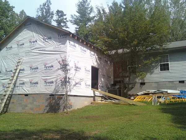 Tyvek wrapped gable on a new room addition beside an existing home in Knox