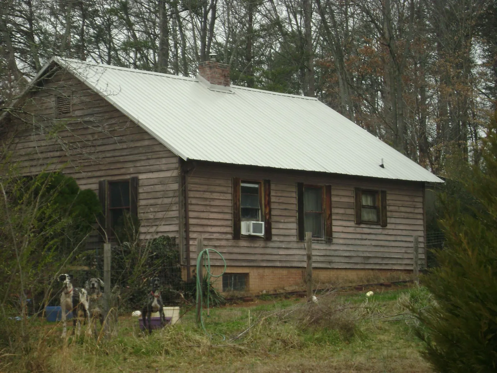 White metal roof on an old wood sided farmhouse, from a Metal Roof Installation job in Knox